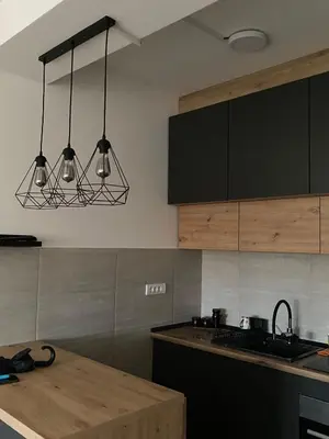 a kitchen with two lights hanging over a counter at Lilyy lux in Leskovac