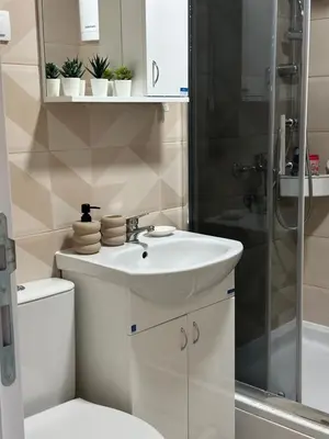 a bathroom with a sink and a shower at Lilyy lux in Leskovac