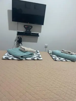two towels on the floor in a room with a tv at Lilyy lux in Leskovac