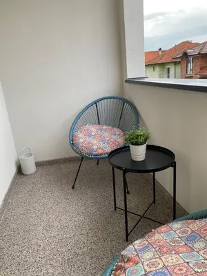 a chair sitting on a balcony with a table at Lilyy lux in Leskovac
