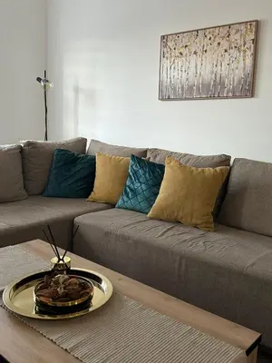 a living room with a couch and a table at Lilyy lux in Leskovac