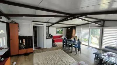 a kitchen and living room with a table and chairs at Krčma u Planini in Bojnik