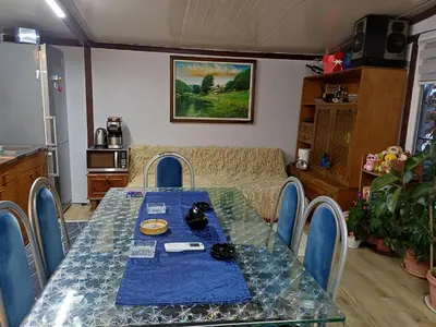 a dining room table with a blue table cloth and a couch at Krčma u Planini in Bojnik