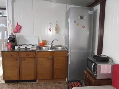a kitchen with a stainless steel refrigerator and a sink at Krčma u Planini in Bojnik