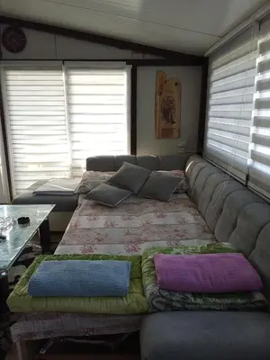 a large couch in a living room with pillows on it at Krčma u Planini in Bojnik