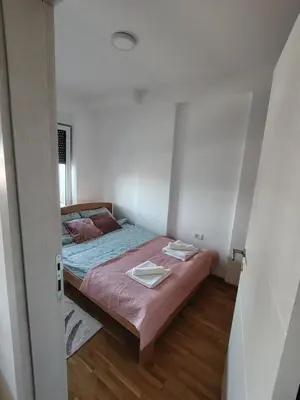a bedroom with a bed with two towels on it at S&B Apartman Vrnjačka Banja in Vrnjačka Banja