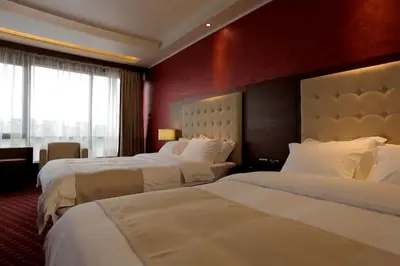 a hotel room with two beds and a large window at Orbis Design Hotel & Spa in Paraćin