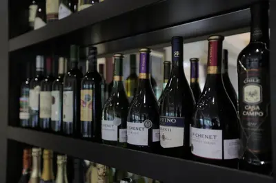 a row of wine bottles sitting on a shelf at Orbis Design Hotel & Spa in Paraćin