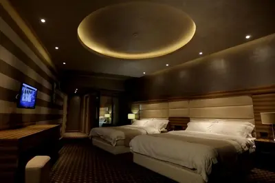 a hotel room with two beds and a tv at Orbis Design Hotel & Spa in Paraćin