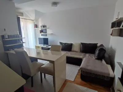 a living room with a table and a couch at NENADOVO in Soko Banja