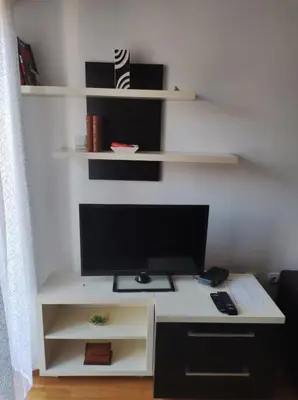 a computer desk with a monitor and a keyboard at NENADOVO in Soko Banja