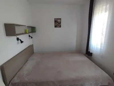 a small room with a bed and a window at NENADOVO in Soko Banja