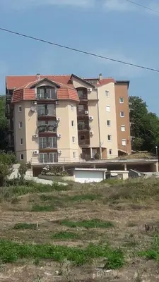 a large apartment building in the middle of a field at NENADOVO in Soko Banja