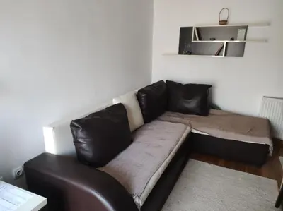 a black leather couch in a living room at NENADOVO in Soko Banja