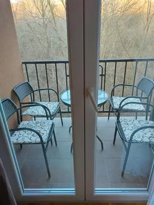 a patio with chairs and tables on a balcony at NENADOVO in Soko Banja