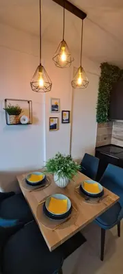 a wooden table with yellow plates on top of it at TopView Milmari N87 in Kopaonik