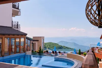 a swimming pool with a view of the mountains at TopView Milmari N87 in Kopaonik