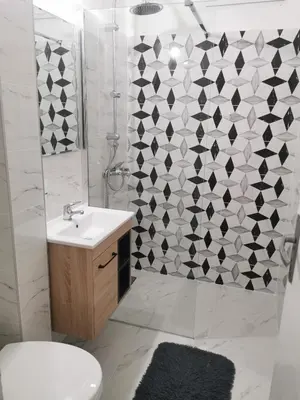 a bathroom with a toilet and a sink and a shower at Apartman Aki in Pirot