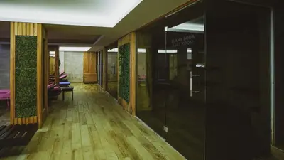 a hallway of a building with glass doors at Milmari Apartman Lucky L03 in Kopaonik