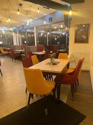 a dining room with a wooden table and chairs at Milmari Apartman Lucky L03 in Kopaonik
