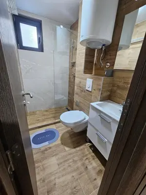 a small bathroom with a toilet and a shower at Apartman Stoiljković in Kopaonik