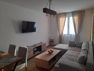 a living room with a couch and a table at Apartman Stoiljković in Kopaonik
