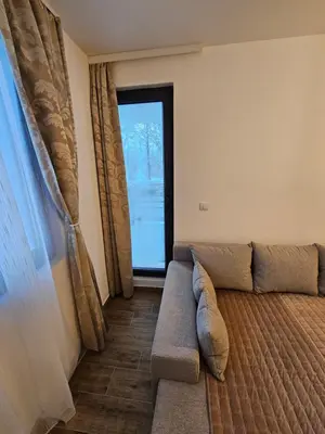 a living room with a couch and a window at Apartman Stoiljković in Kopaonik