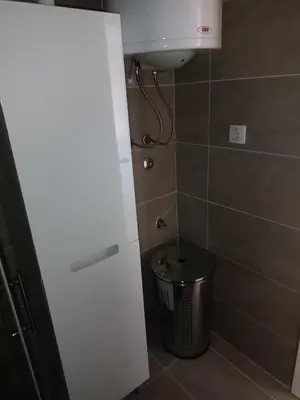 a bathroom with a sink and a trash can at Apartman MASTER Porta Infinitas in Vrnjačka Banja