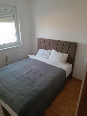 a large bed in a bedroom with a window at Apartman MASTER Porta Infinitas in Vrnjačka Banja