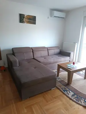 a living room with a couch and a coffee table at Apartman MASTER Porta Infinitas in Vrnjačka Banja