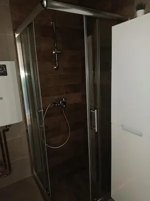a shower with a glass door in a bathroom at Apartman MASTER Porta Infinitas in Vrnjačka Banja