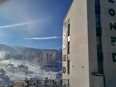 a building with a view of a snow covered mountain at Stefany in Kopaonik