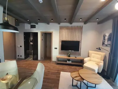 a living room with a television and a table and chairs at Stefany in Kopaonik