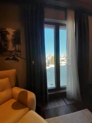a living room with a window and a couch and a view at Stefany in Kopaonik
