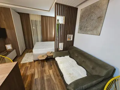 a living room with a couch and a bed at Apartman Košuta-Prezident in Kopaonik