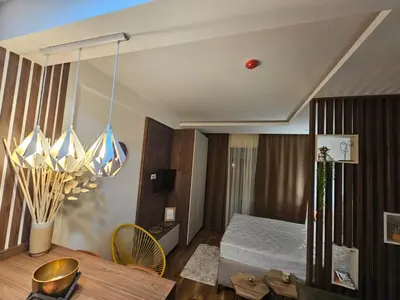 a hotel room with a bed and a table at Apartman Košuta-Prezident in Kopaonik