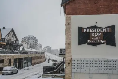 a sign on the side of a building in the snow at Apartman Košuta-Prezident in Kopaonik