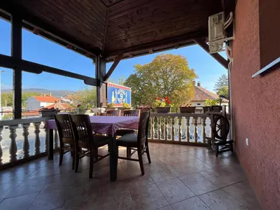a table and chairs on a balcony with a view at 9 mezeta in Pirot