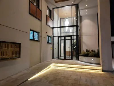 a hallway with a large glass door in a building at Boho style in Jagodina