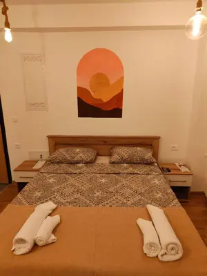 a bedroom with two beds with white towels on them at Boho style in Jagodina