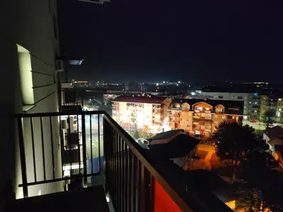 a view of a city at night from a balcony at Boho style in Jagodina