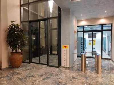 a lobby with glass doors and a potted plant at Boho style in Jagodina