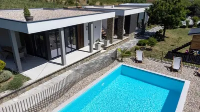 an aerial view of a house with a swimming pool at Duos West in Soko Banja