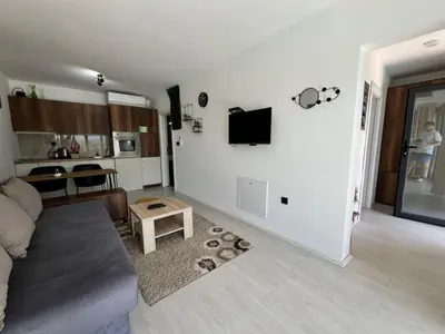a living room with a couch and a tv on a wall at Duos West in Soko Banja