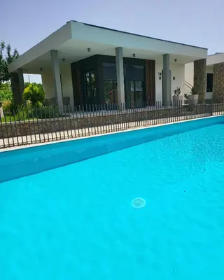 a house with a swimming pool in front of a house at Duos West in Soko Banja