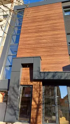 a building with a wooden roof on the side of it at MOZAIK APARTMENTS & SPA - Modern 4-Star Apartments with Exclusive Private SPA WELLNESS in the City Center - SAUNA, JACUZZI, TURKISH BATH - FREE PARKING, Wi-FI - Rooms & Apartments Cuprija in Ćuprija
