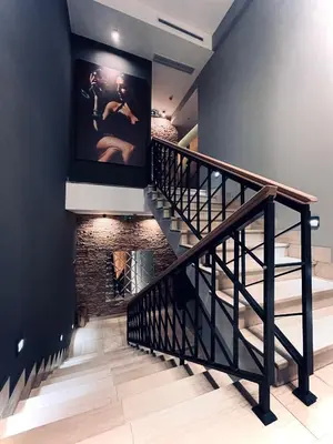 a staircase in a house with a brick wall at MOZAIK APARTMENTS & SPA - Modern 4-Star Apartments with Exclusive Private SPA WELLNESS in the City Center - SAUNA, JACUZZI, TURKISH BATH - FREE PARKING, Wi-FI - Rooms & Apartments Cuprija in Ćuprija