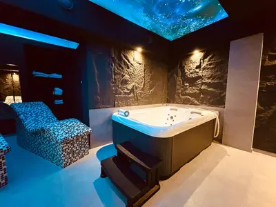 a bath tub in a room with a star ceiling at MOZAIK APARTMENTS & SPA - Modern 4-Star Apartments with Exclusive Private SPA WELLNESS in the City Center - SAUNA, JACUZZI, TURKISH BATH - FREE PARKING, Wi-FI - Rooms & Apartments Cuprija in Ćuprija