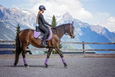 a woman is riding a horse in the mountains at Ibis Lux Milmari Apartman N51 Kopaonik Panorama Spa in Kopaonik