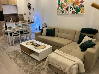 a living room with a couch and a table at Milmari N lux Sena in Kopaonik